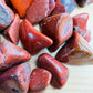 Top view of Red Jasper tumbled stone, carried for Grounding, showing earthy tone.
