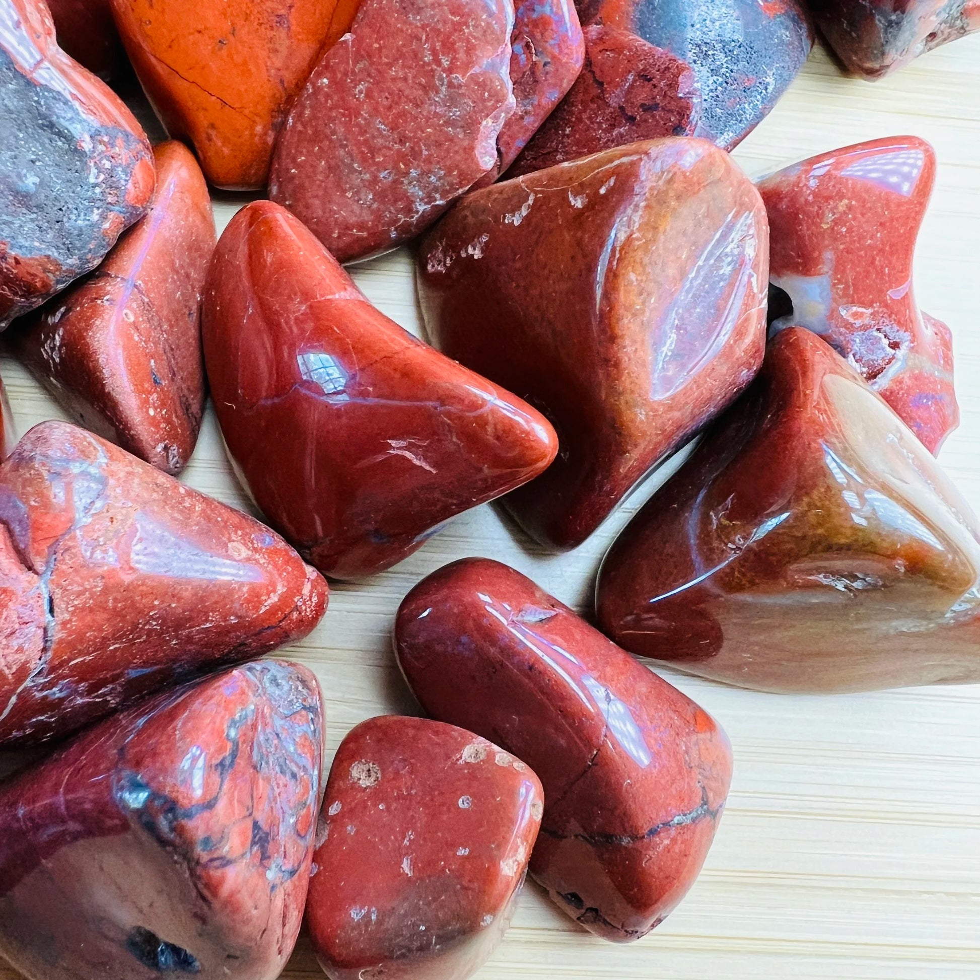 Top view of Red Jasper tumbled stone, carried for Grounding, showing earthy tone.