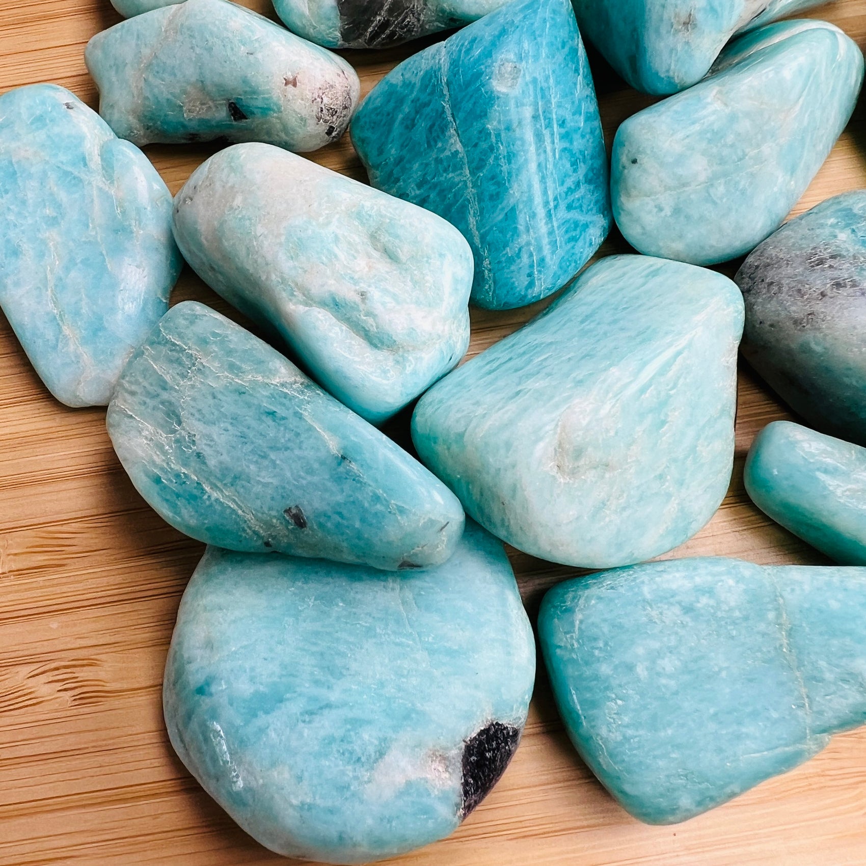 Close-up detail of Grade AA Amazonite tumbled stone showing natural blue, green tones and texture