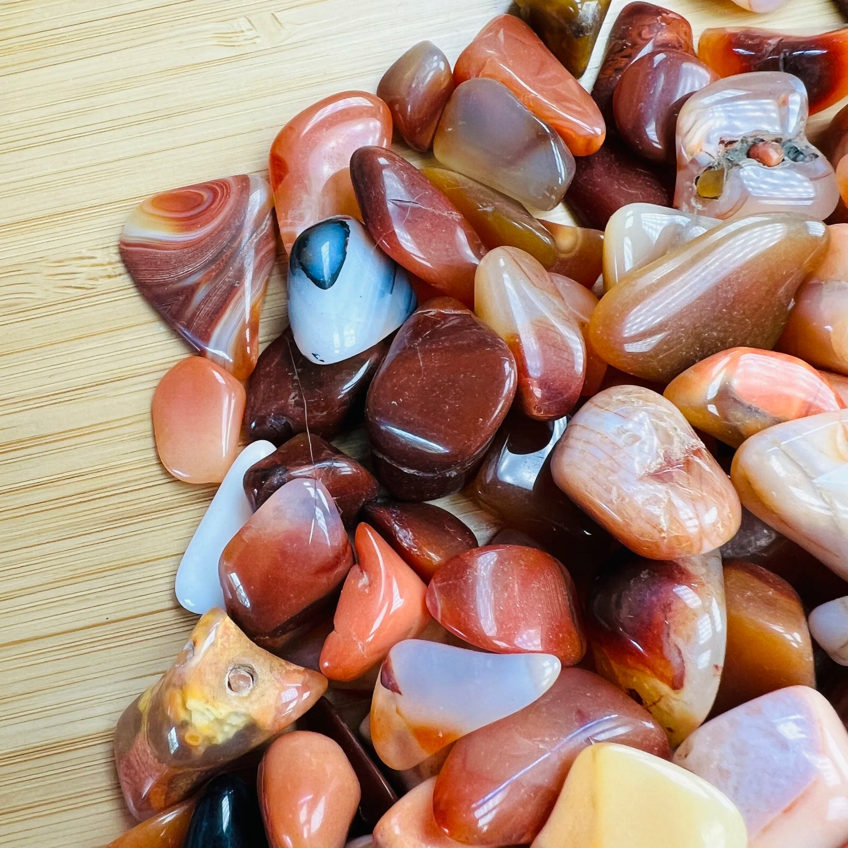 Profile shot of Carnelian tumbled stone, showing characteristic patterning.