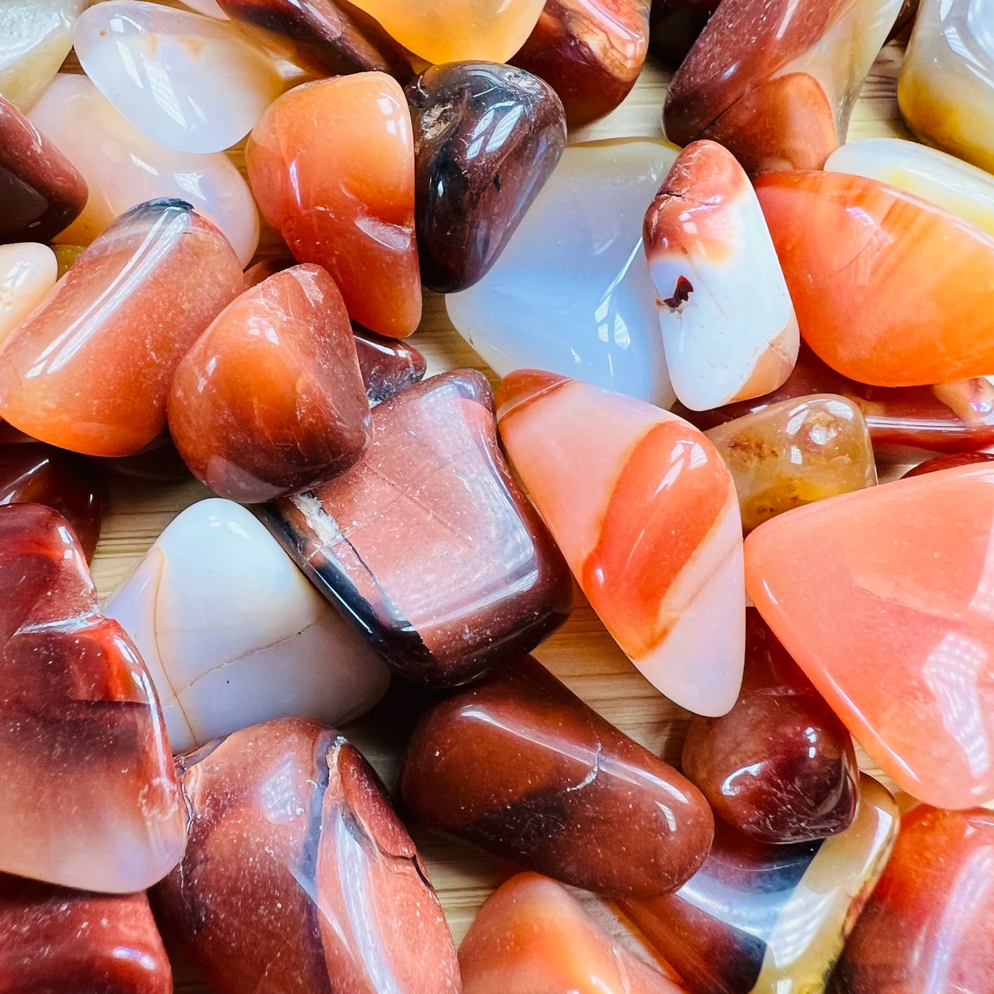 Top view of Grade AA Carnelian tumbled stone, sourced from Boeny, Madagascar