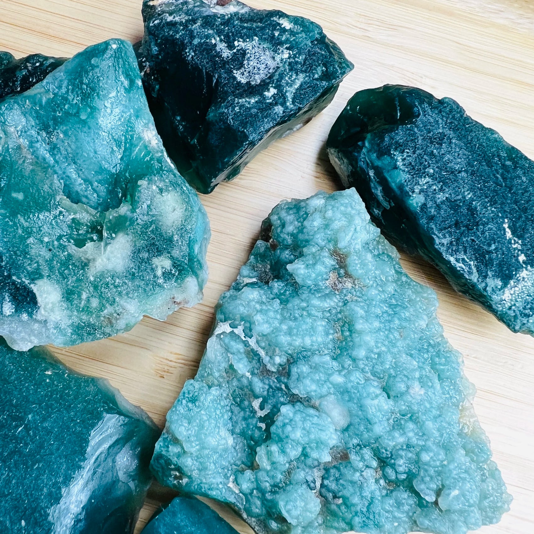 Size comparison with a Chalcedony raw stone held against natural backdrop, from Zimbabwe.