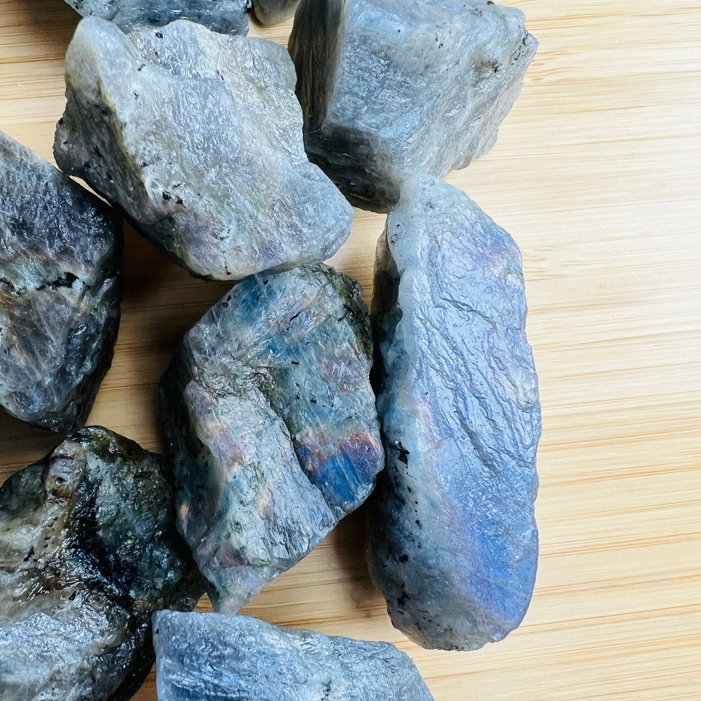 Hand-scale view of Labradorite raw crystal, from Atsimo-Andrefana, Madagascar, set to give a sense of weight.