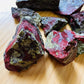 Macro view of Grade AA Dragon Bloodstone raw stone, kept near for Confidence and Energy.