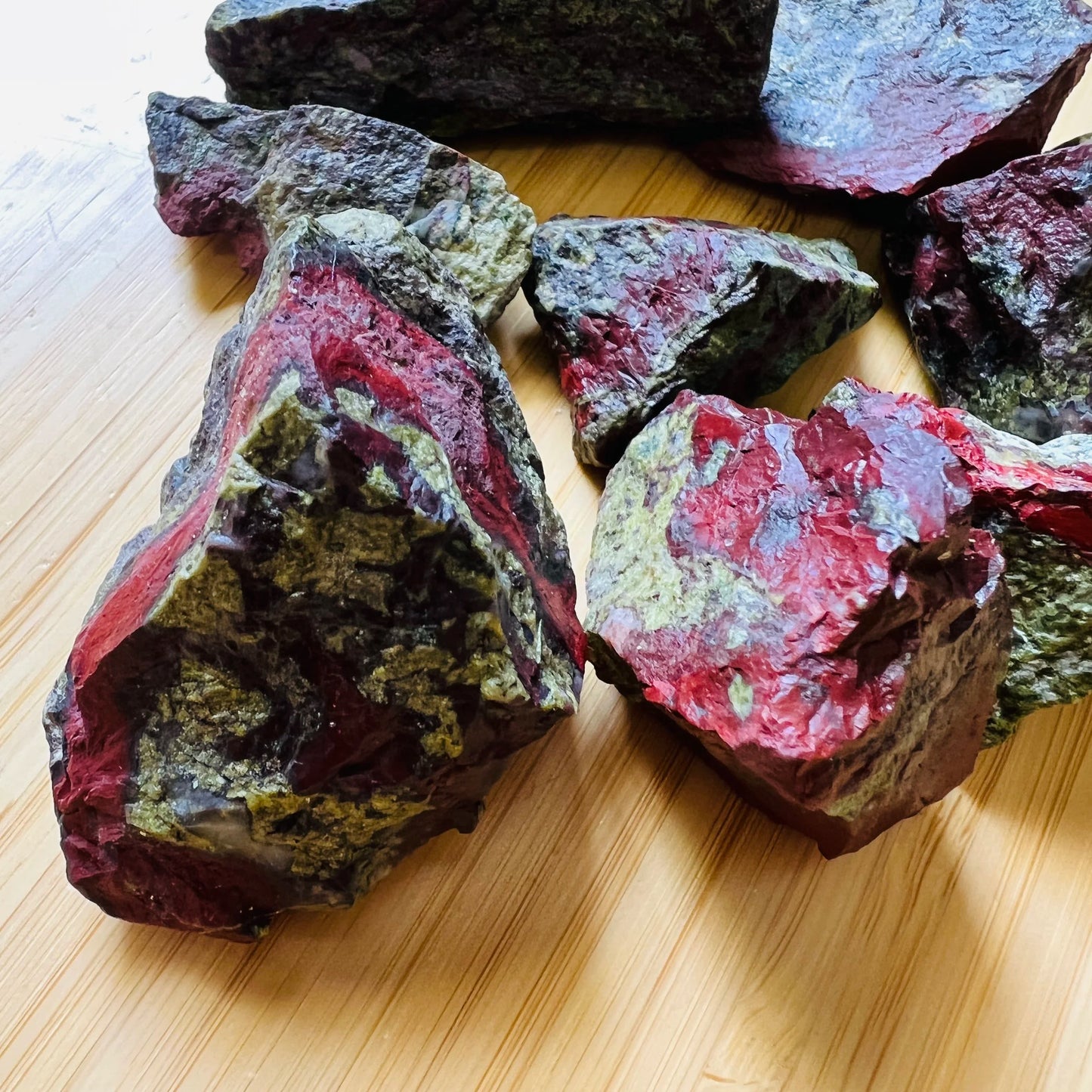 Macro view of Grade AA Dragon Bloodstone raw stone, kept near for Confidence and Energy.