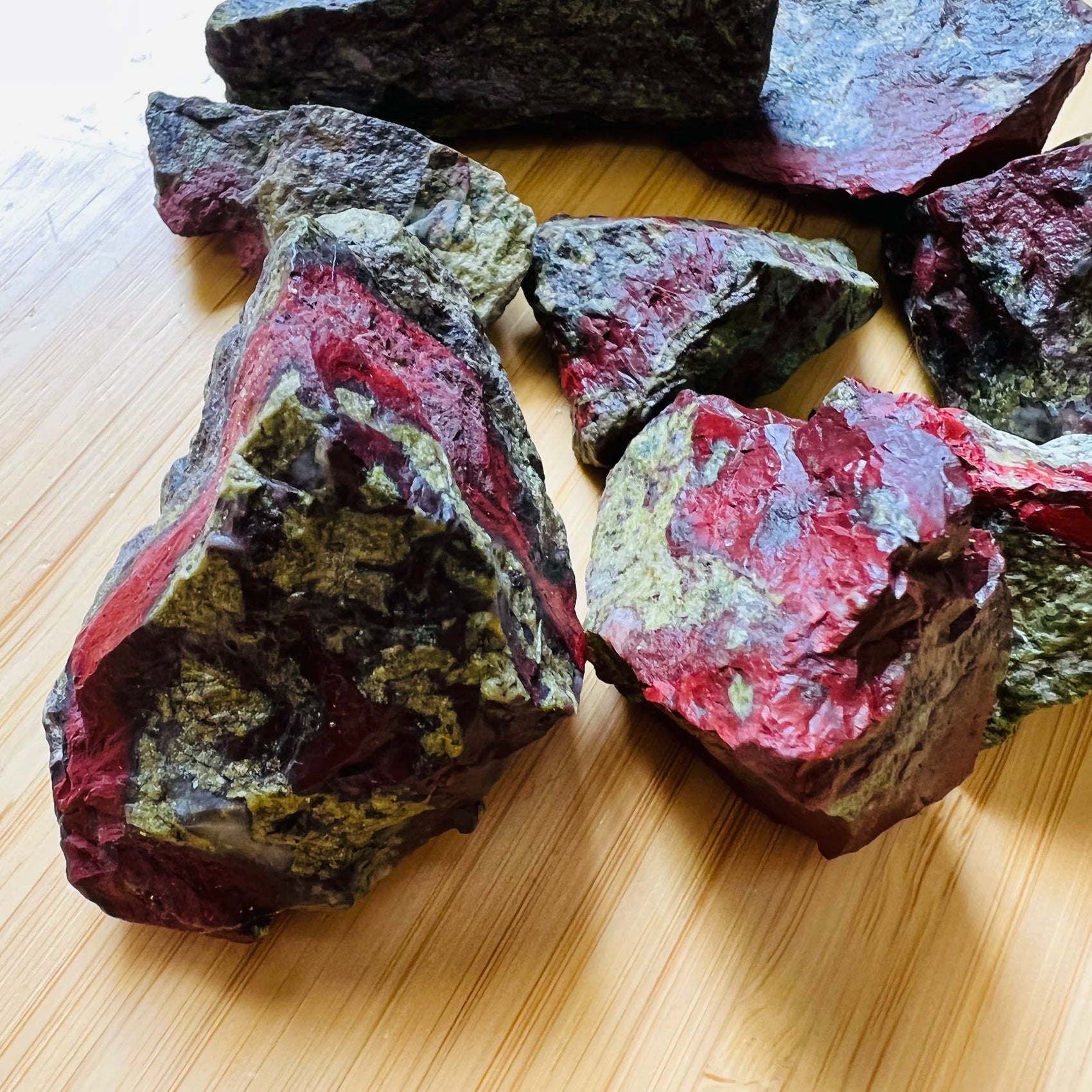 Macro view of Grade AA Dragon Bloodstone raw stone, kept near for Confidence and Energy.