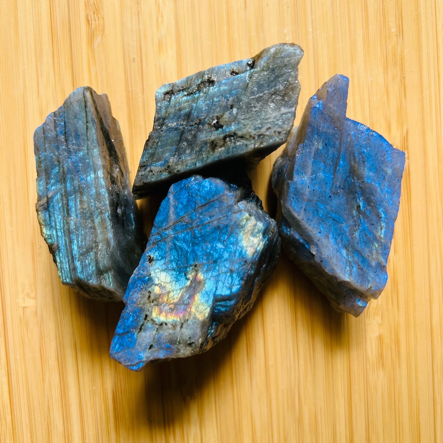 Close-up detail of Grade AAA Labradorite raw showing natural gray, rainbow tones and texture