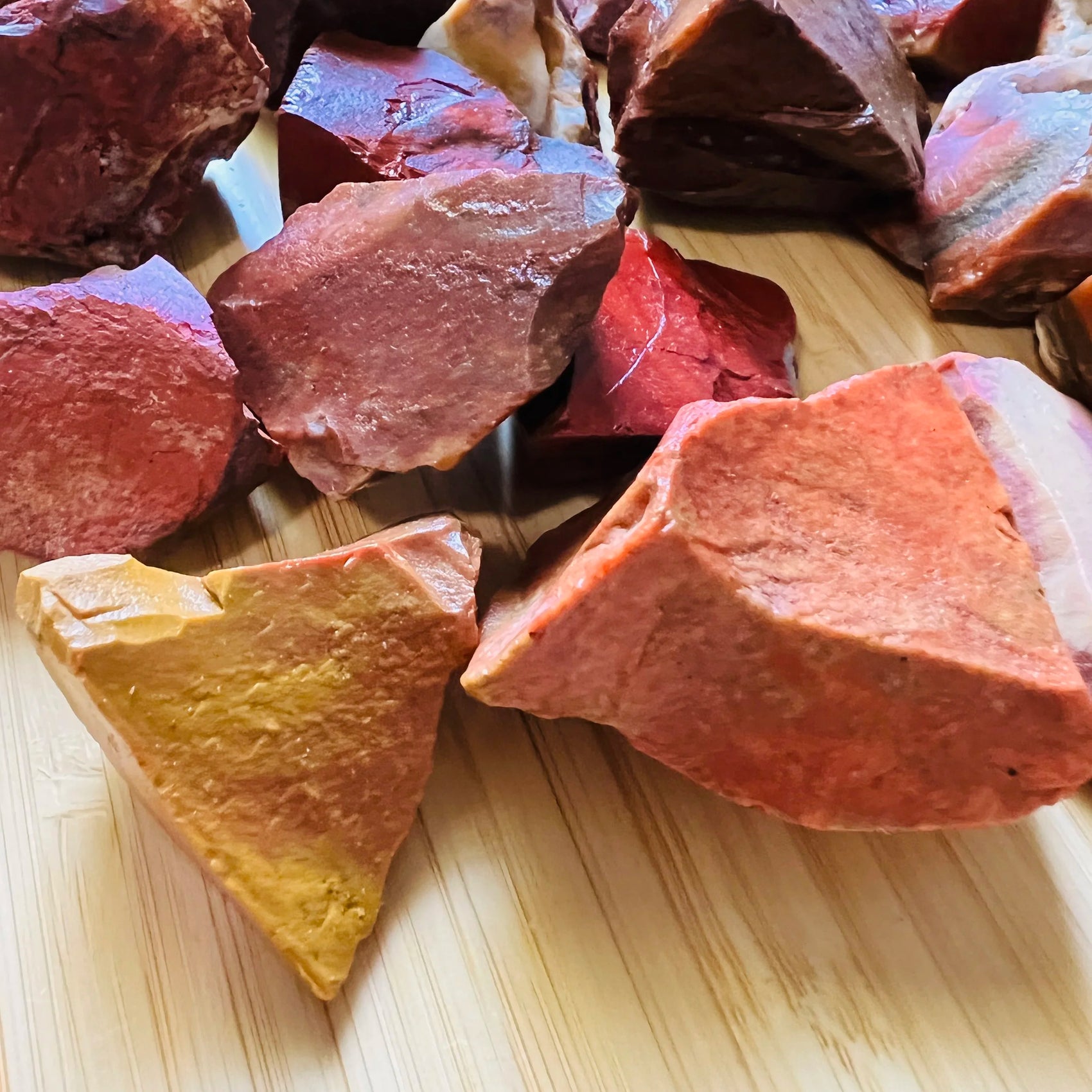Detail of Grade AA Red Jasper raw stone, Madagascar-sourced, showing characteristic patterning.
