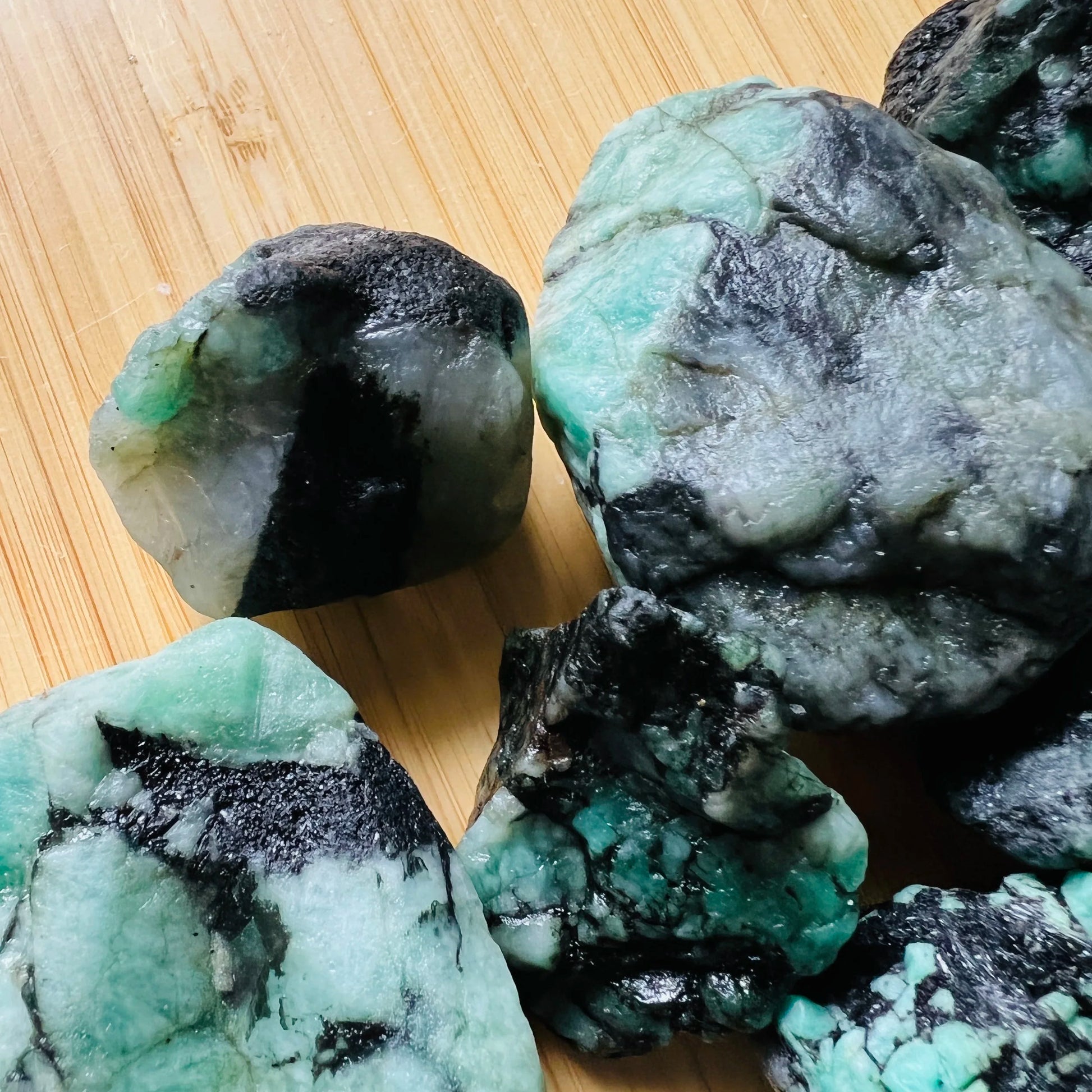 Palm-scale view of one Emerald raw stone for scale, from Brazil.