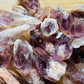 Natural light view of one Amethyst raw point for scale, sourced from Zambia.