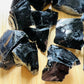 Back view of Grade AA Black Obsidian raw showing natural surface