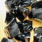 Detail shot of Grade AA Black Obsidian raw under natural light