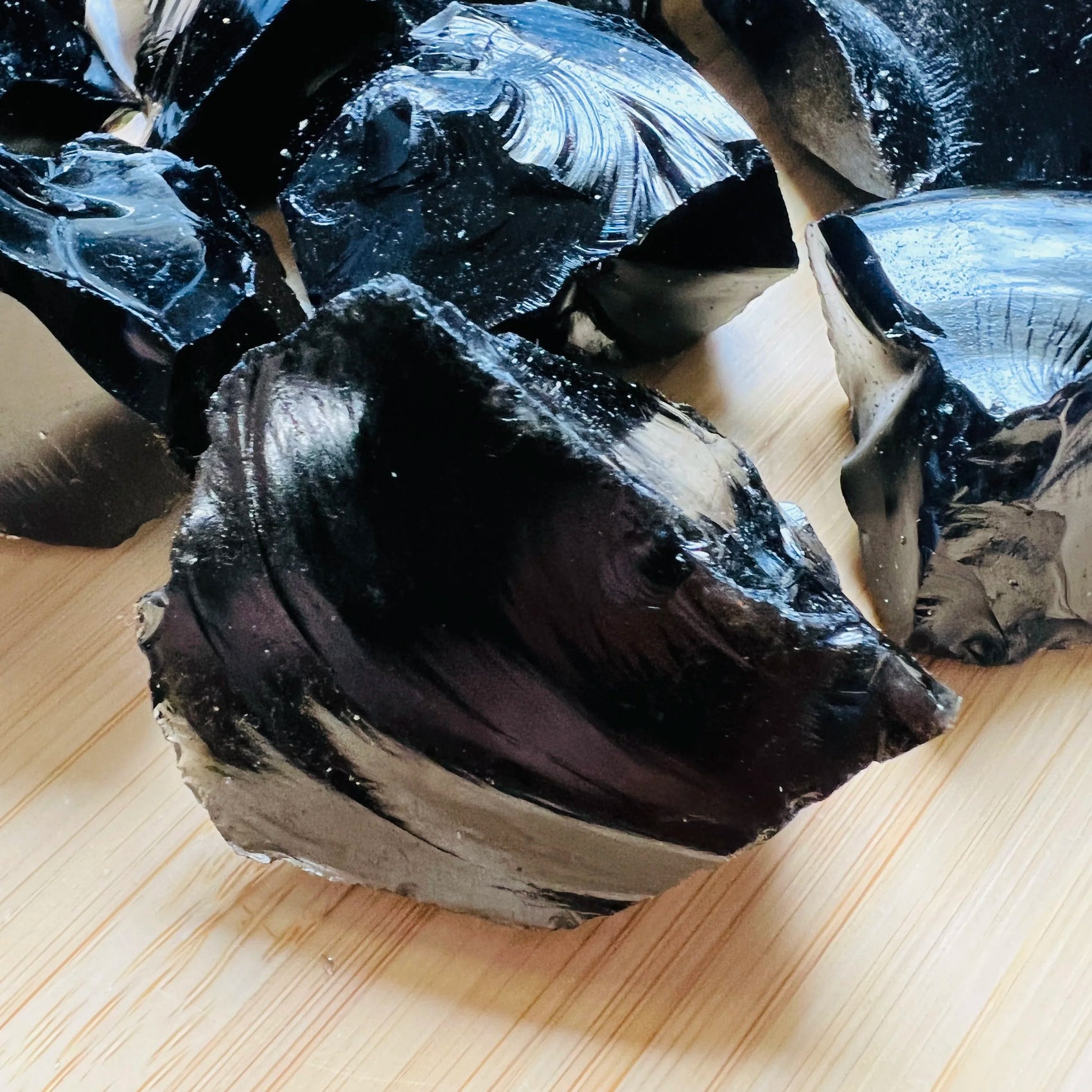 Close-up of Black Obsidian raw stone from Argentina, soothing wellness stone for Emotional Healing
