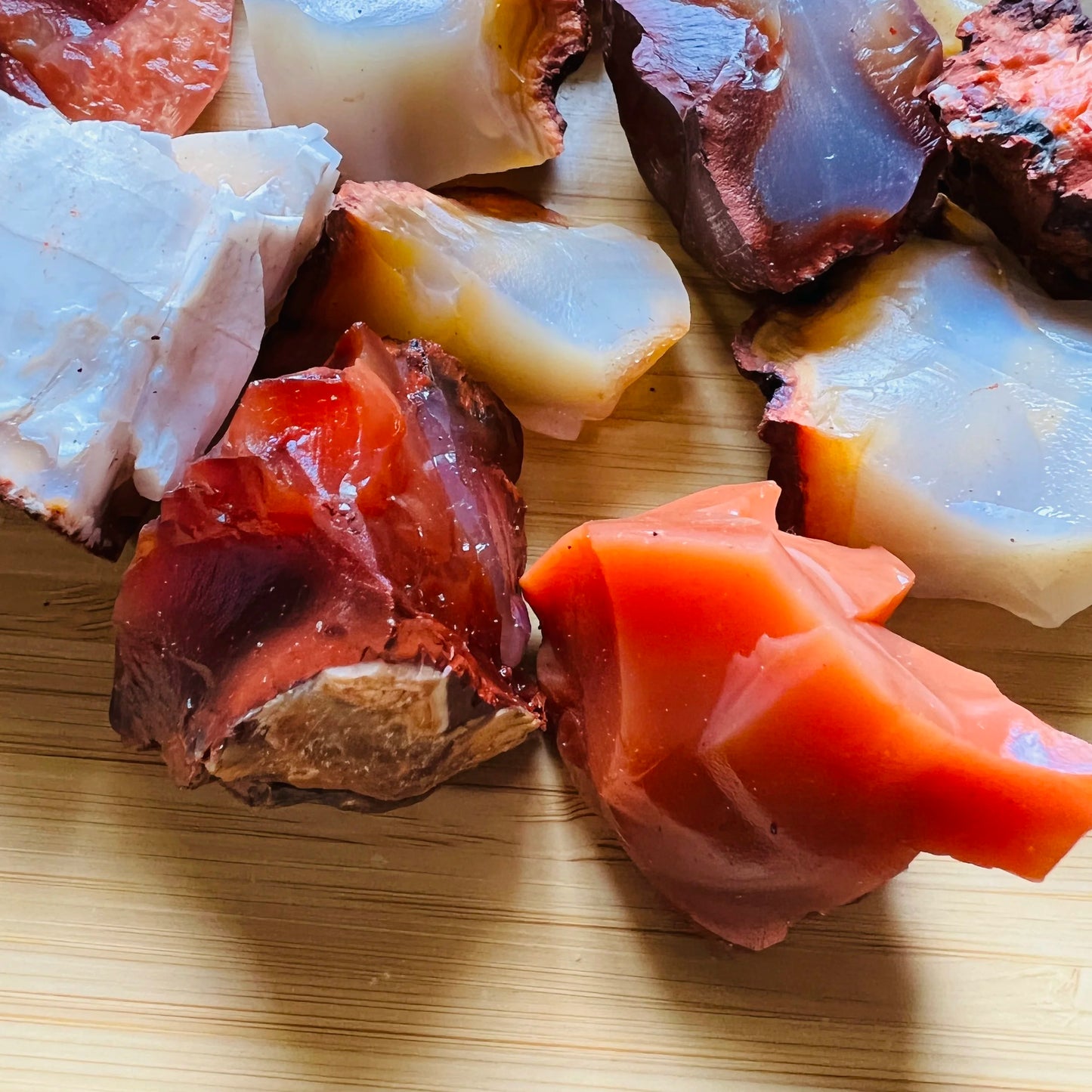 Side profile of Grade AA Carnelian raw with natural form and inclusions