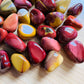 Top angle of Mookaite tumbled stone, often kept for Grounding.