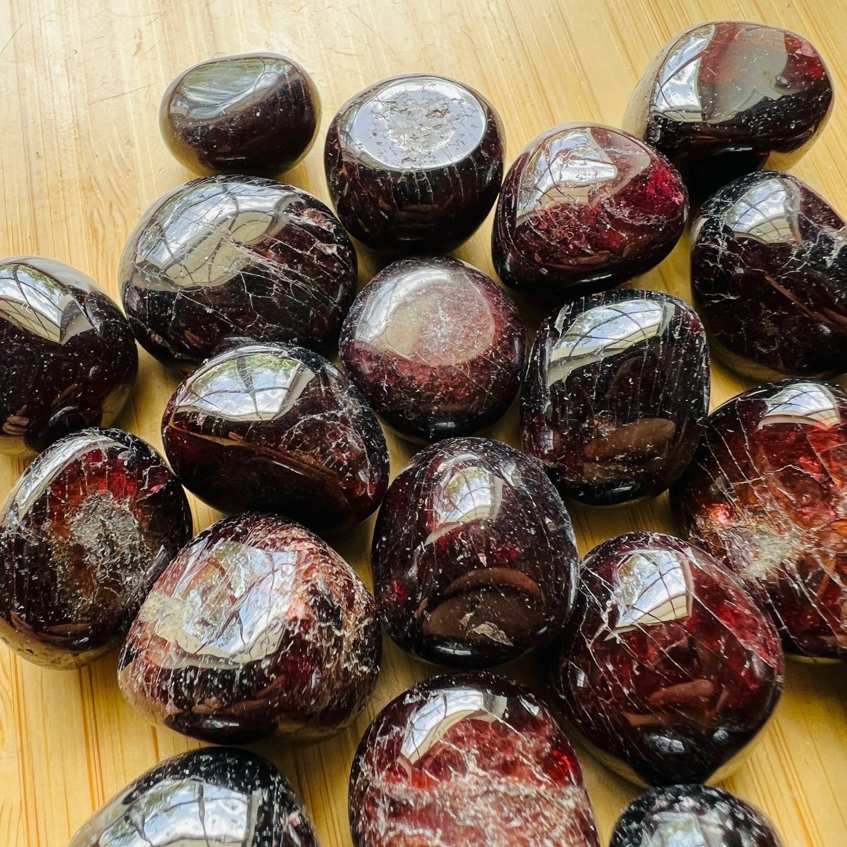 Sideways view of Garnet tumbled stone, showing natural sheen, linked to Energy and Confidence.