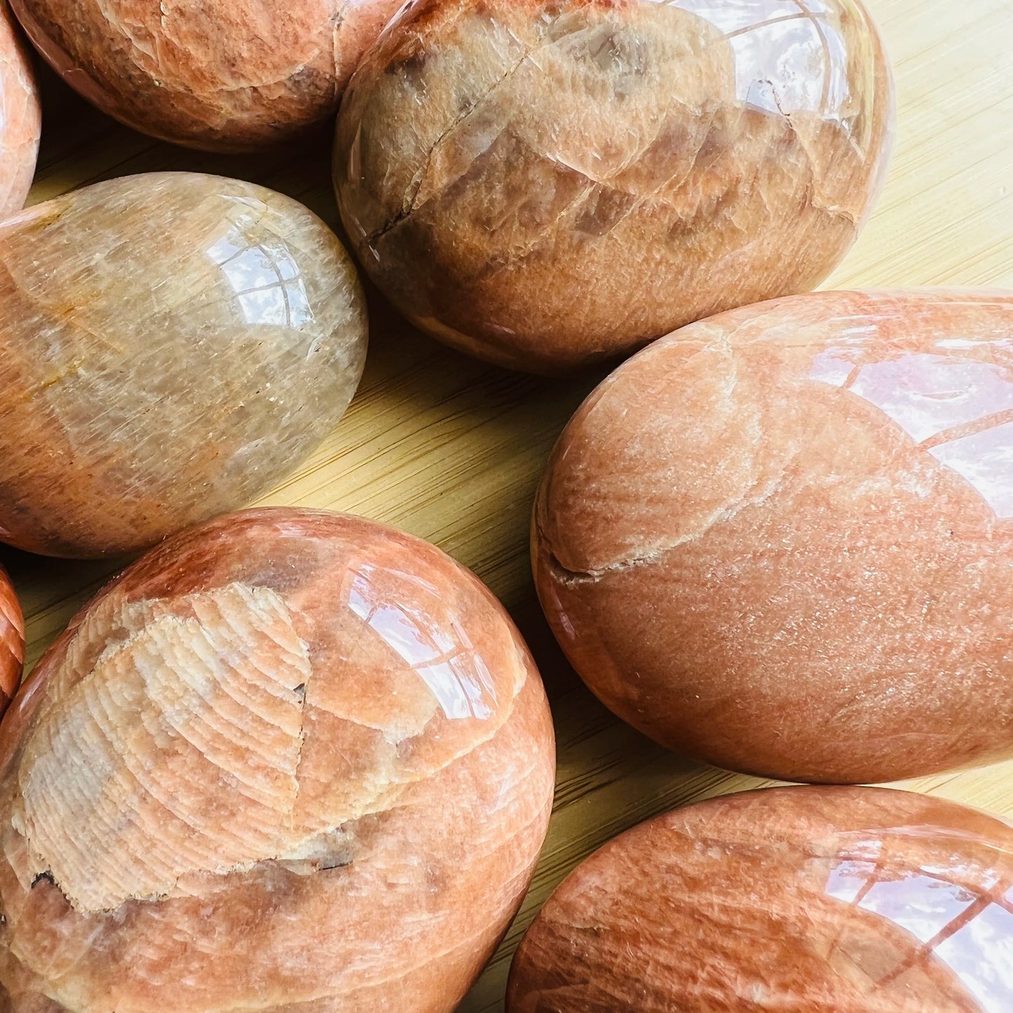 Bird's-eye view of Grade AA Peach Moonstone palm stone, traditionally used for Emotional Healing.