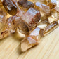 Opposite side of Natural Citrine raw point, showing characteristic color.
