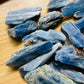 Natural light view of a Blue Kyanite raw stone often kept for Confidence, Brazil-sourced.