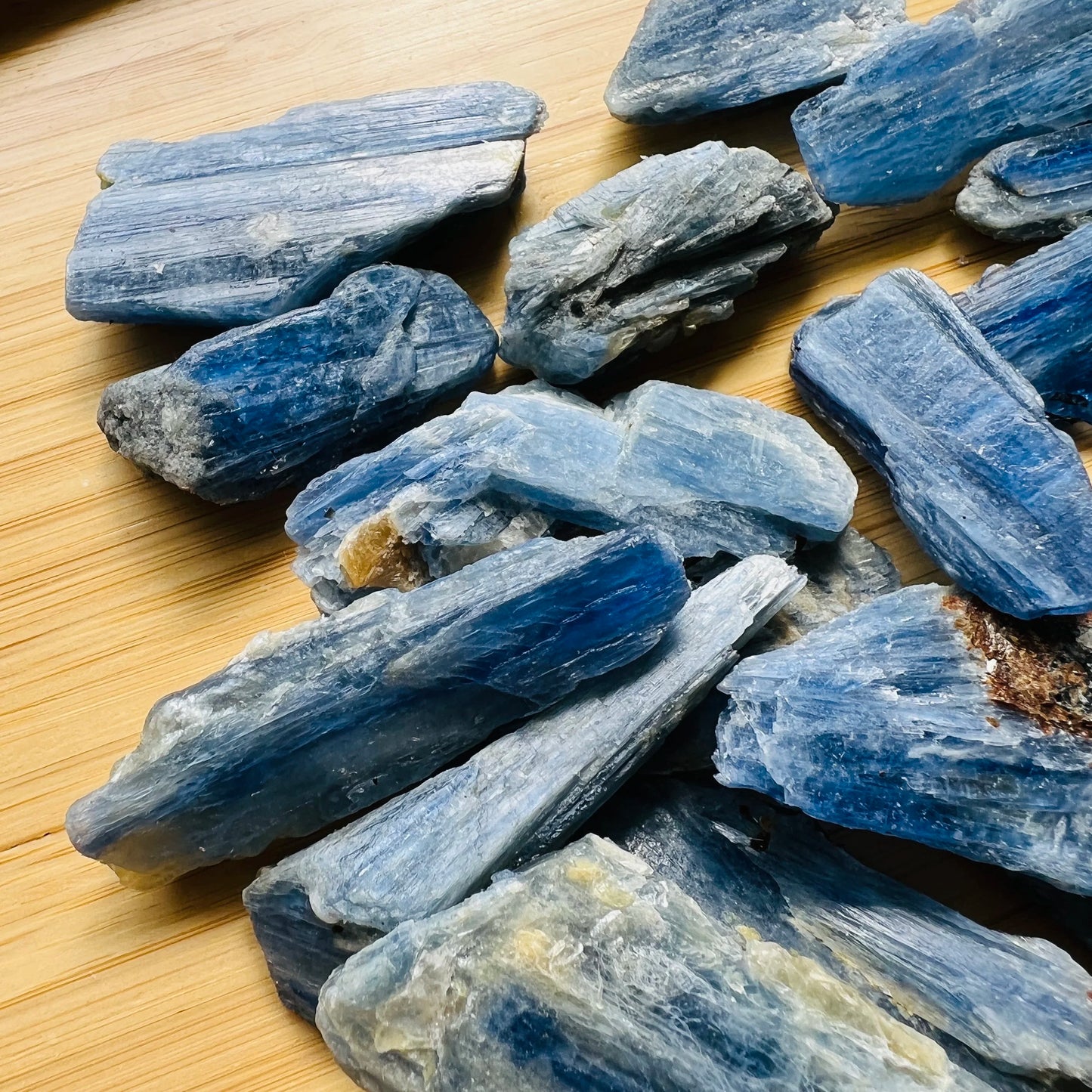 Natural light view of a Blue Kyanite raw stone often kept for Confidence, Brazil-sourced.