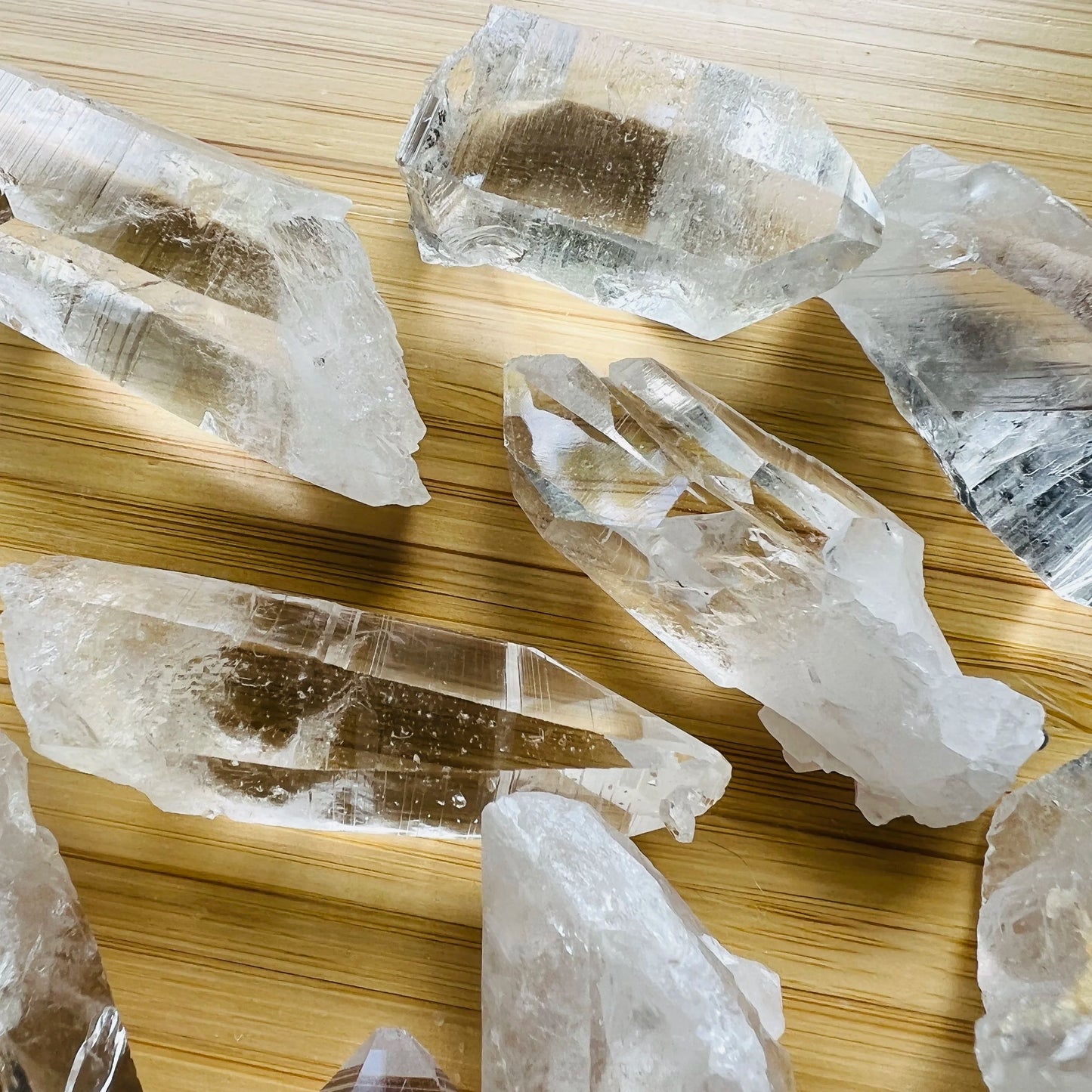 Three-quarter view of Clear Quartz raw crystal, from Arkansas, United States, associated with Healing, shown in a calm studio setting.