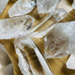 Back view of Grade AAA Clear Quartz point showing natural surface