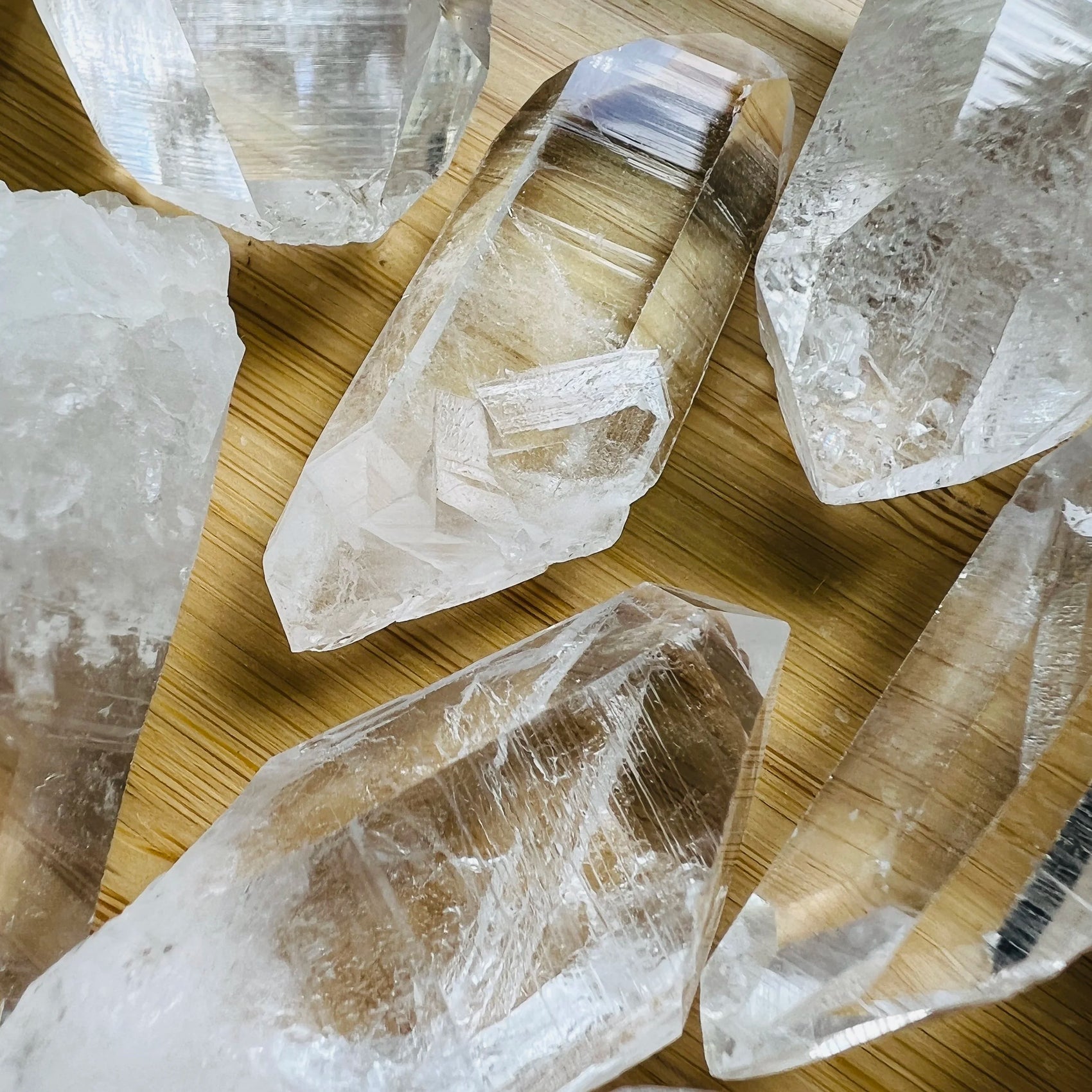 Side perspective of Clear Quartz raw point, sourced from United States, showing natural sheen.