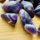 Magnified detail of purple Chevron Amethyst tumbled stone, often worked with for Intuition, sourced from Copperbelt Province.