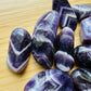 Lateral view of Chevron Amethyst tumbled stone, to support Intuition, showing characteristic color.