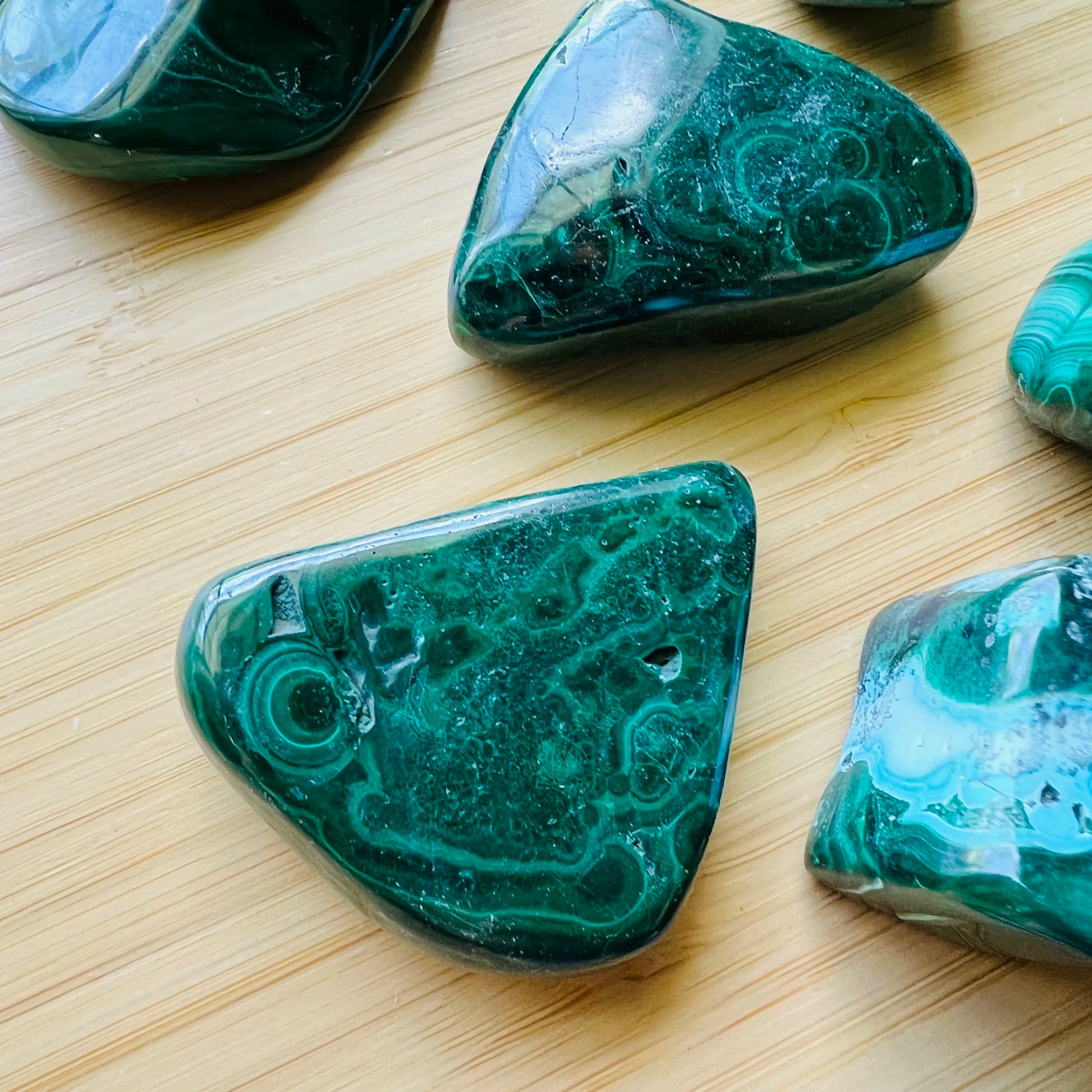 Companion image of Malachite tumbled stone, from Haut-Katanga, Democratic Republic of the Congo, showing the full body of the piece.