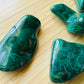 Back view of Grade AA Malachite tumbled stone showing natural surface