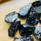 Grade aa snowflake obsidian raw held in hand for size reference