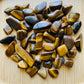 Back view of Grade A Tiger Eye tumbled stone showing natural surface
