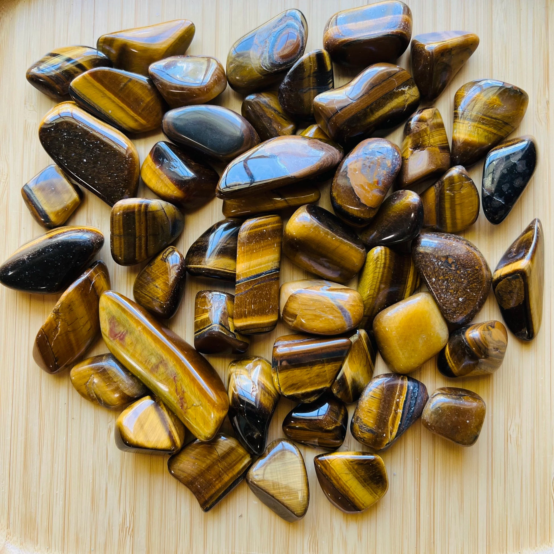 Back view of Grade A Tiger Eye tumbled stone showing natural surface