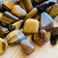 Full profile of Grade A Tiger Eye tumbled stone ready to ship from Beyond Bohemian