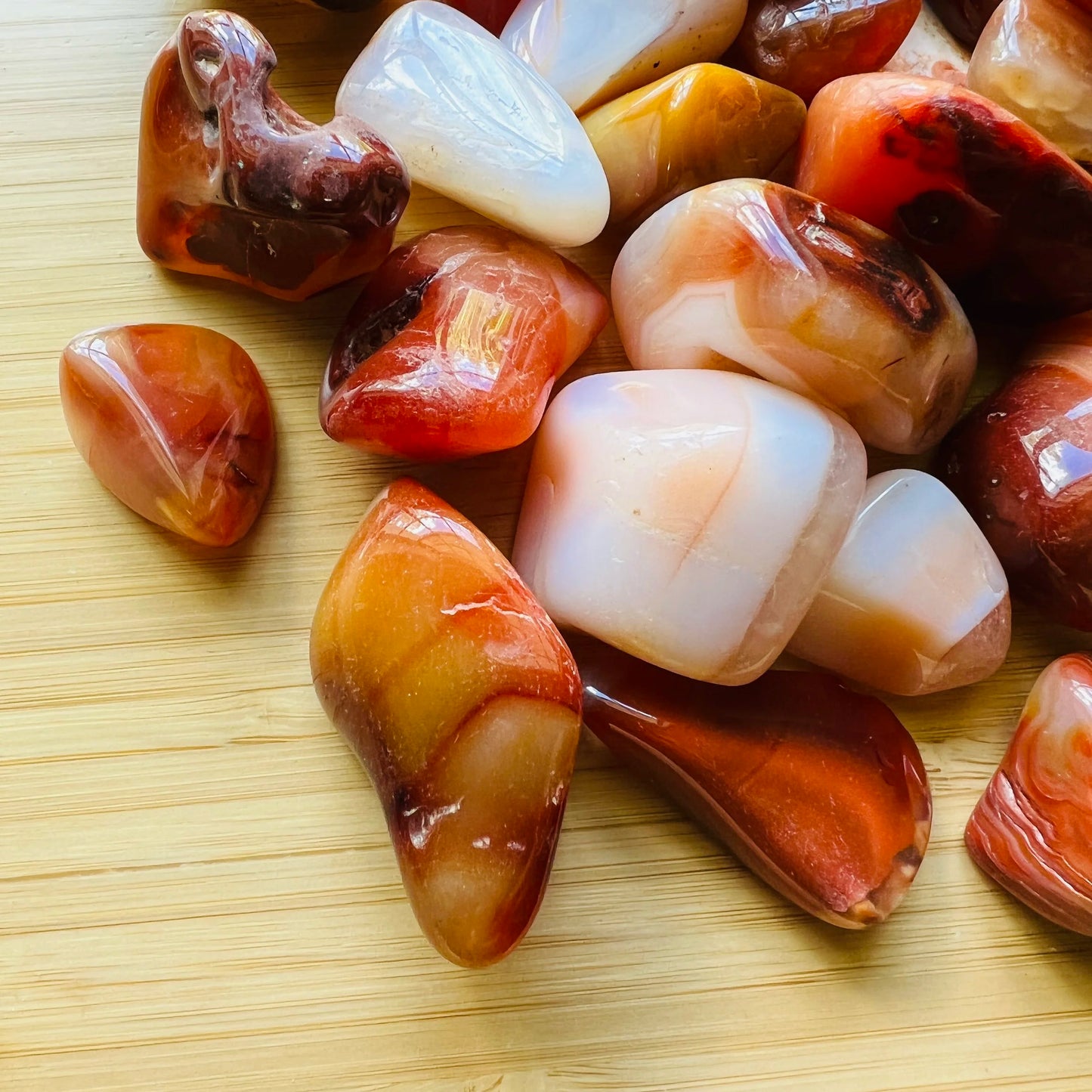 Side profile of Grade AA Carnelian tumbled stone with natural form and inclusions