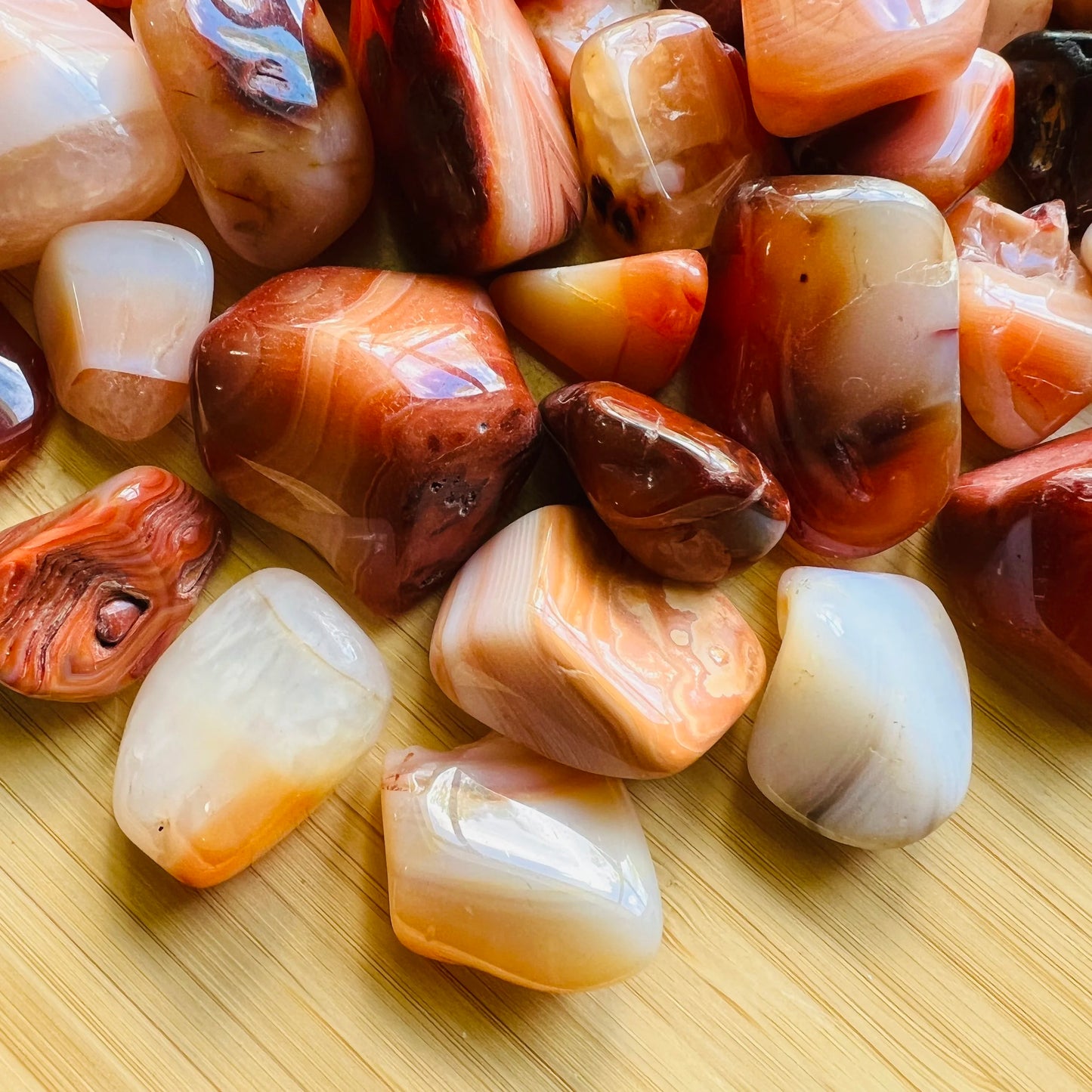 Top view of Grade AA Carnelian tumbled stone, sourced from Boeny, Madagascar