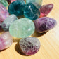 Alternate angle of Grade AA Fluorite tumbled stone, associated with Focus, showing subtle veining.