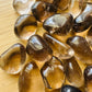 Back view of Grade AAA Smoky Quartz tumbled stone showing natural surface