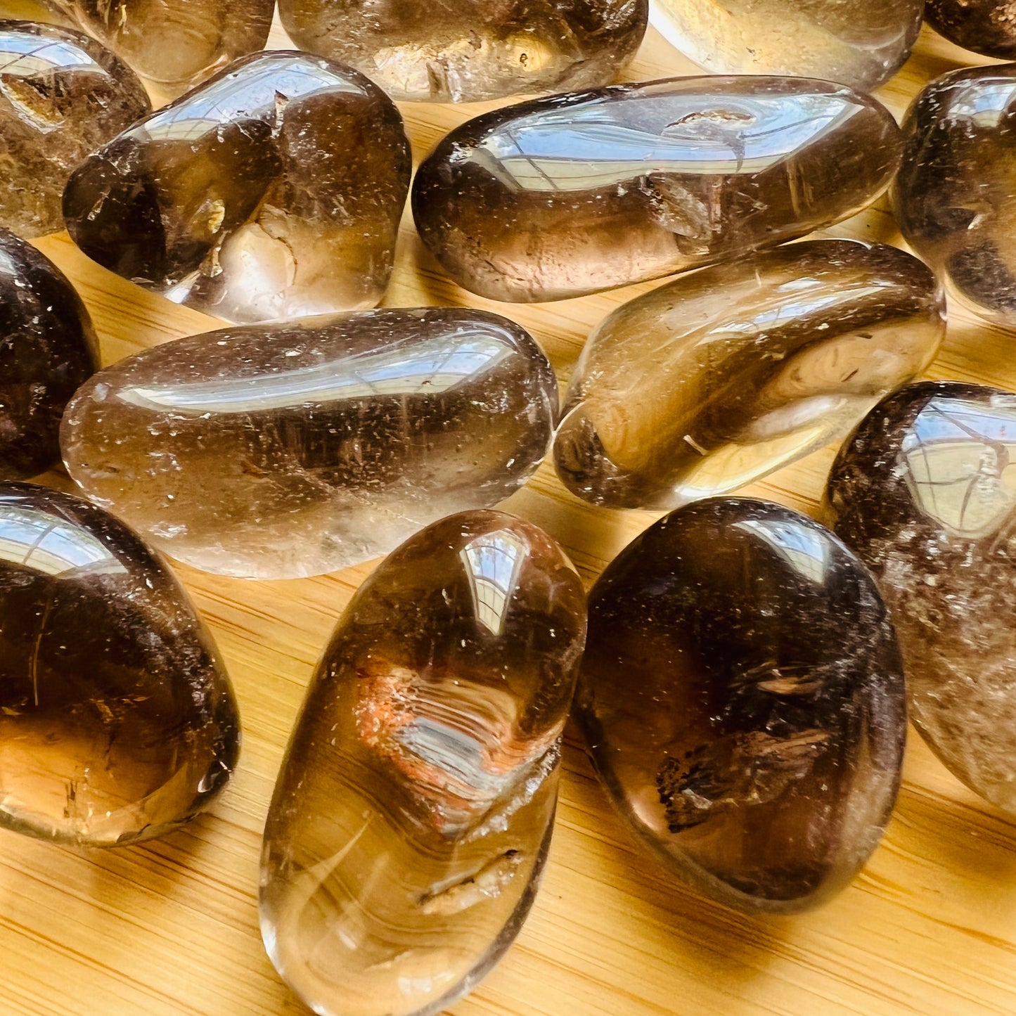 Edge view of Smoky Quartz tumbled stone, showing characteristic color, sourced from Brazil.