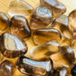 Detail shot of Grade AAA Smoky Quartz tumbled stone under natural light