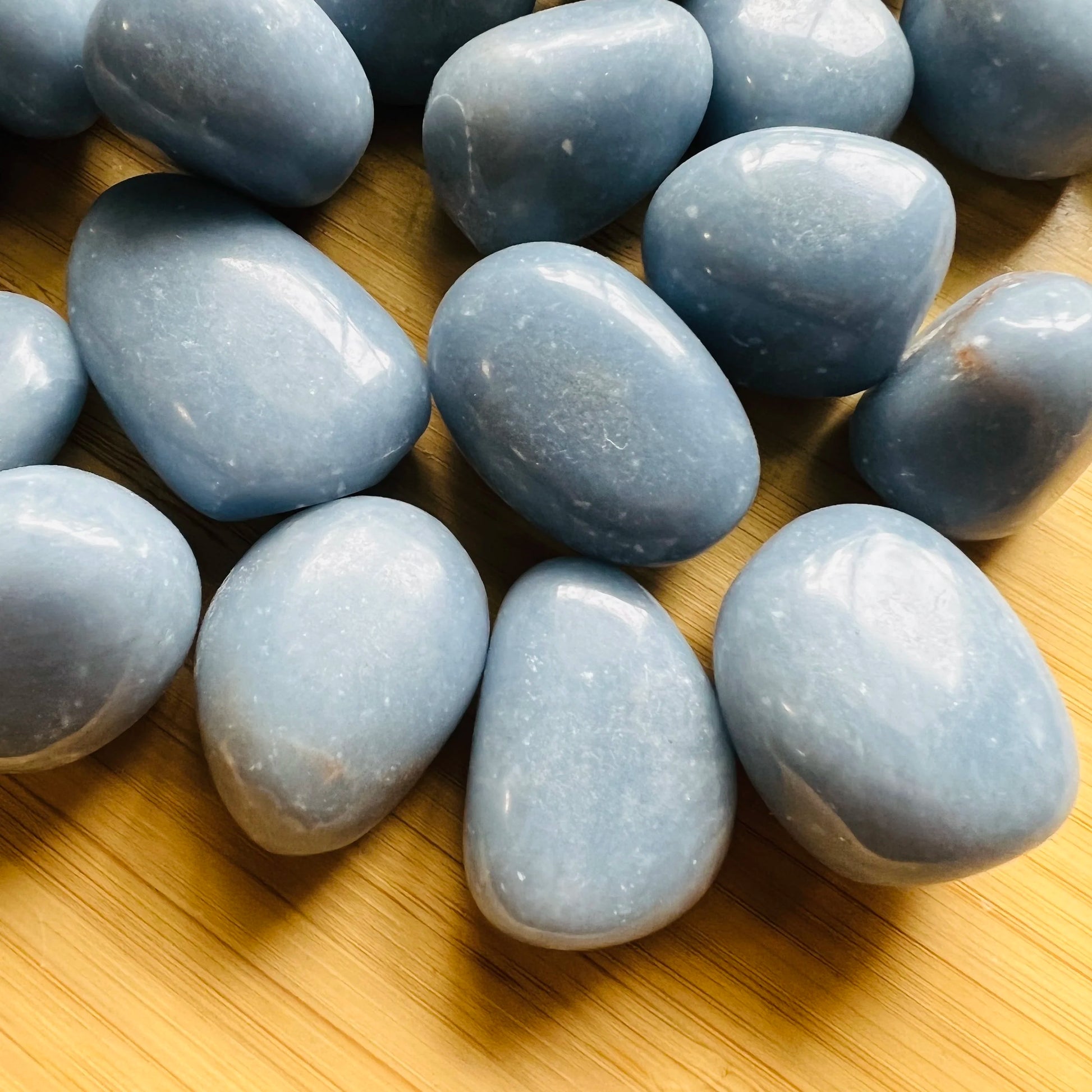 Edge view of Angelite tumbled stone, often worked with for Stress Relief and Meditation, hand-selected from Huarochirí, Peru.