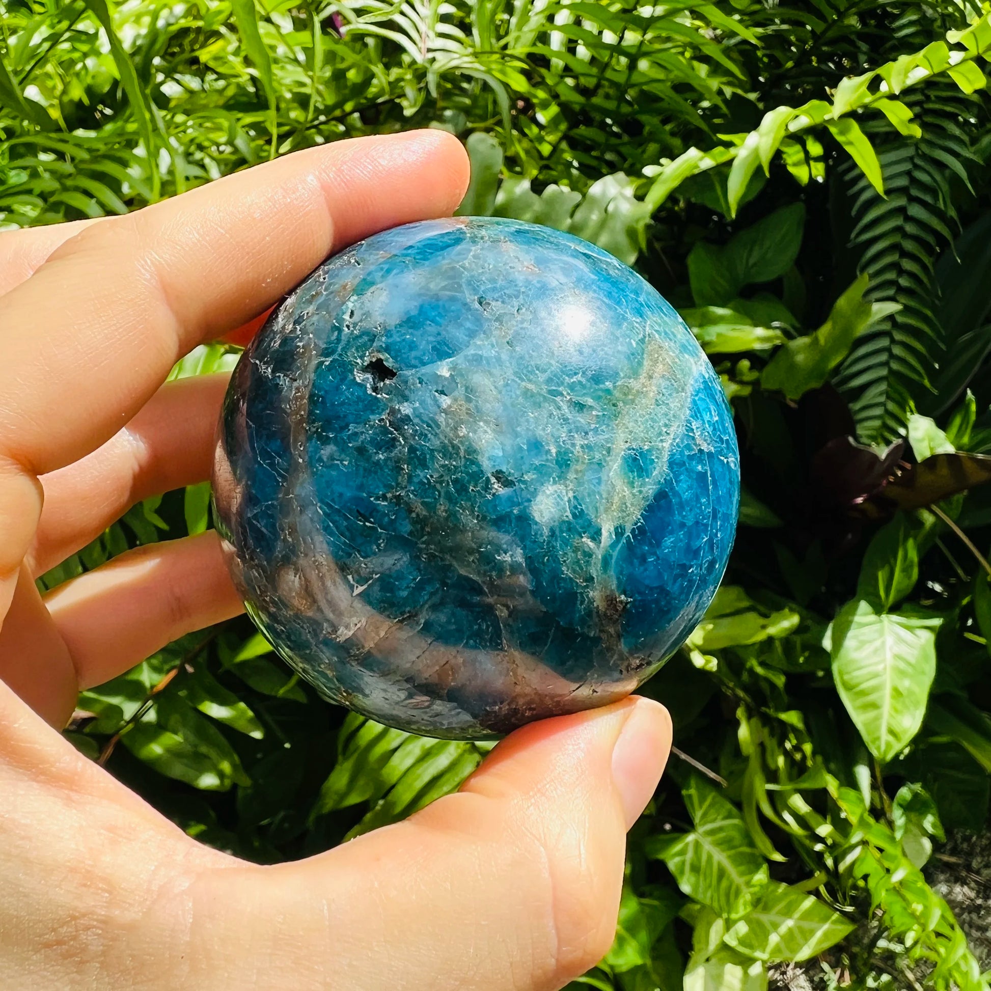 Side perspective of Apatite polished sphere, showing characteristic patterning.