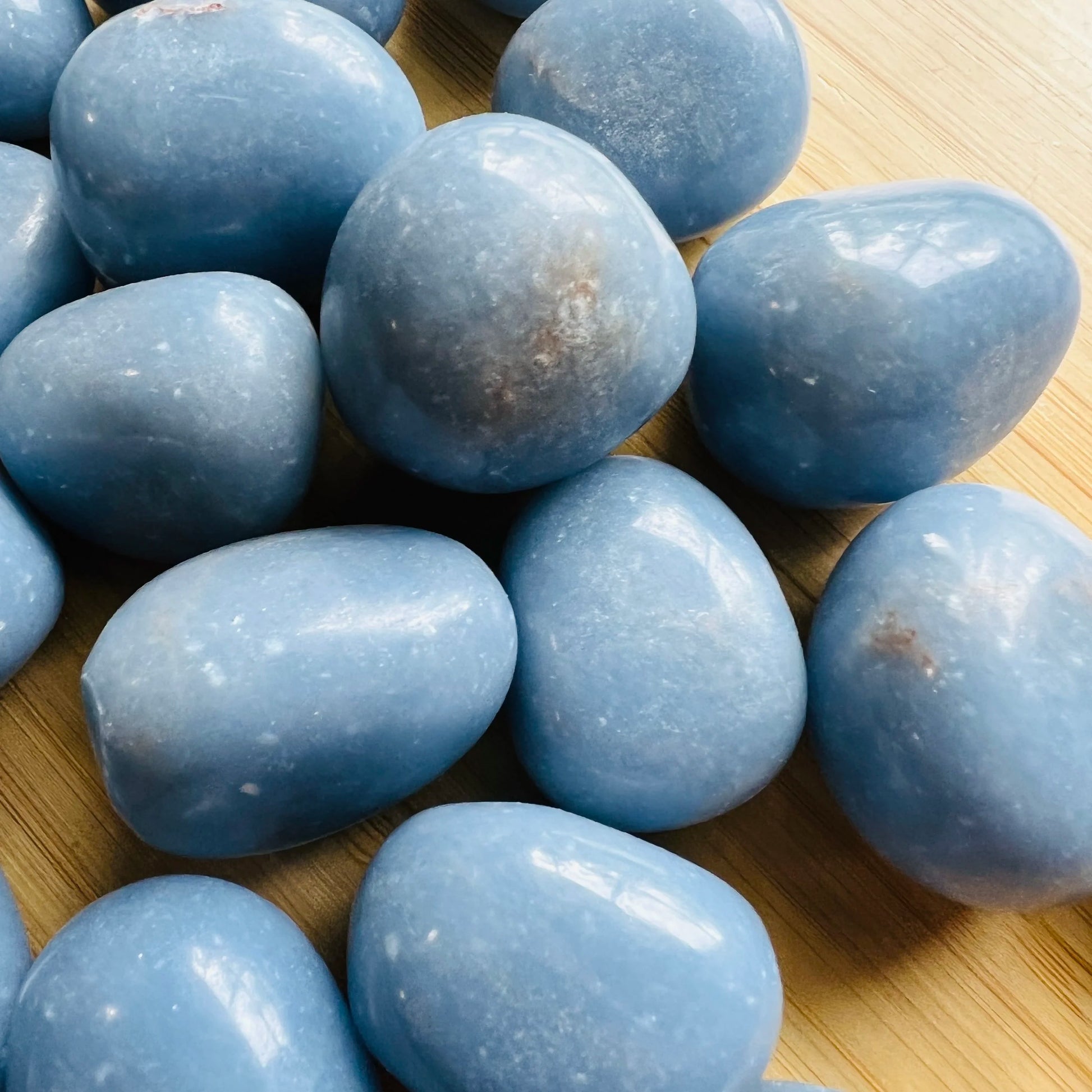 Bottom side of Angelite tumbled stone, showing characteristic color.