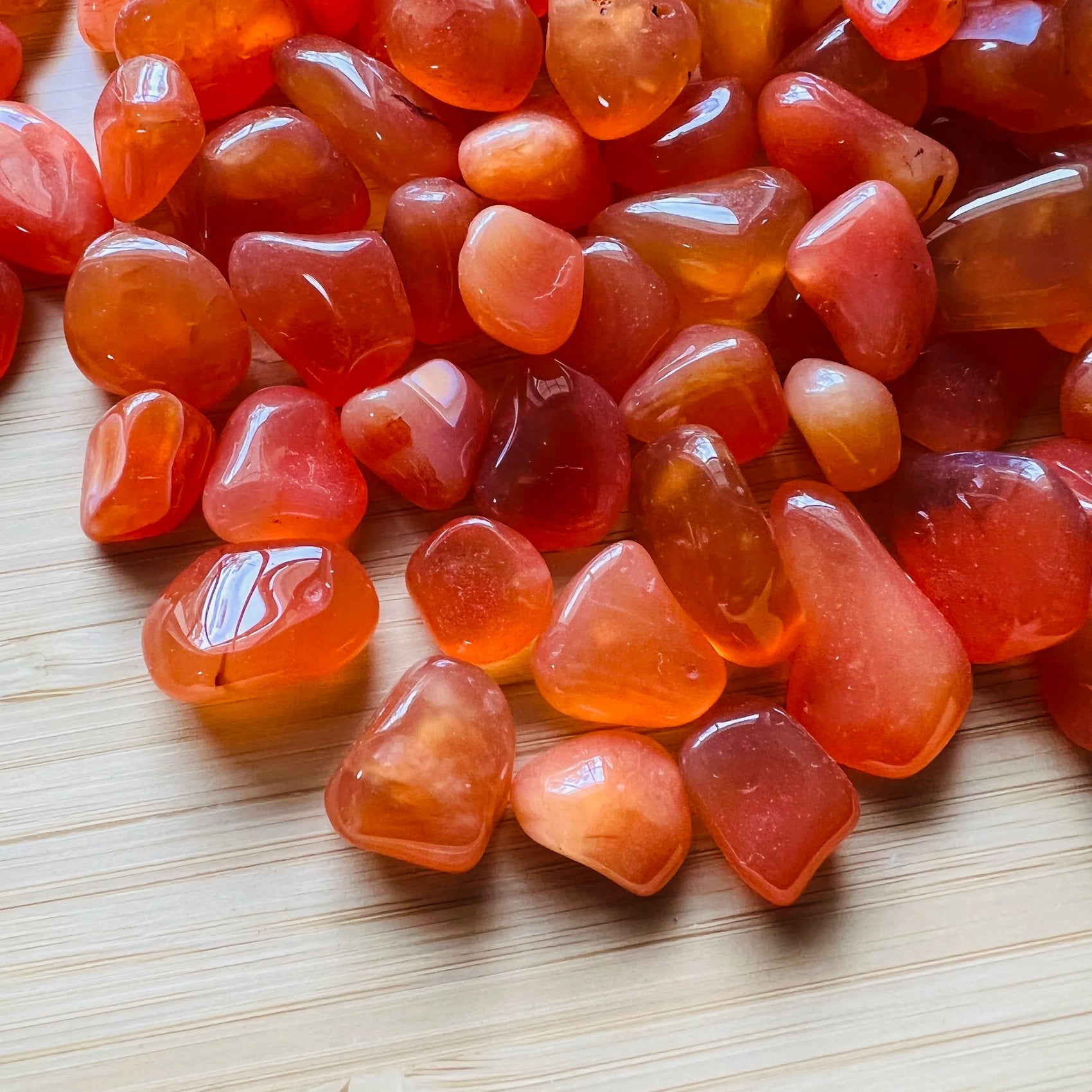 Texture-level view of orange Carnelian tumbled stone, turned to for Energy and Confidence, Botswana-sourced.
