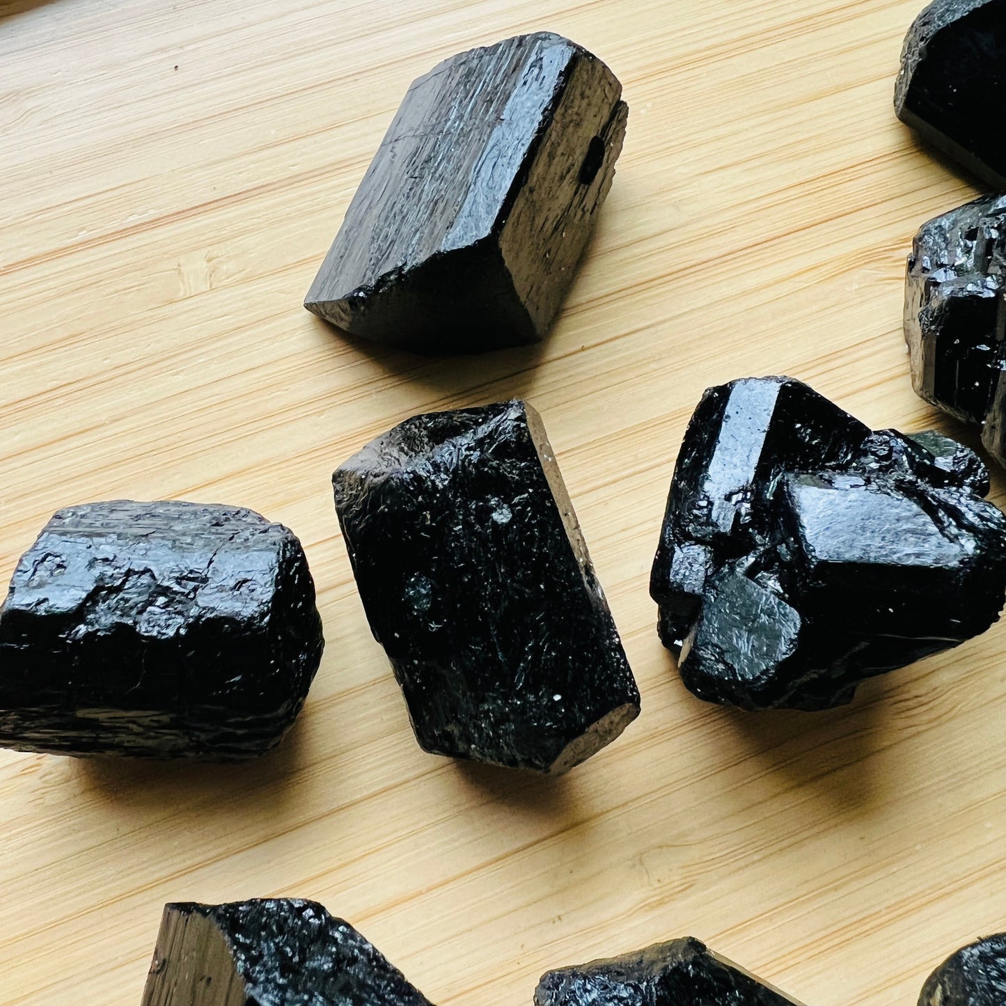 Close-up detail of Grade AA Black Tourmaline raw showing natural black tones and texture