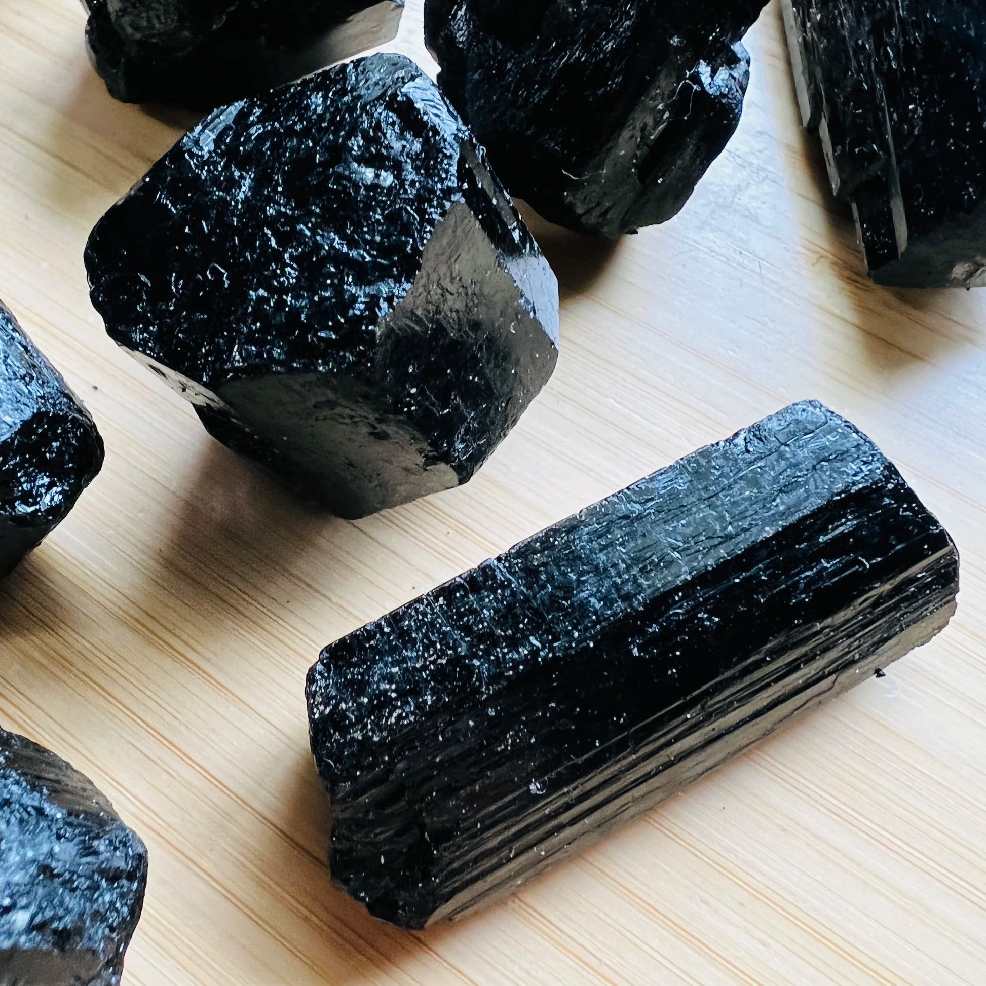 Side profile of Grade AA Black Tourmaline raw with natural form and inclusions