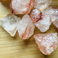 Side perspective of Grade AA Fire Quartz raw stone, showing natural variation, worked with for Grounding and Confidence.