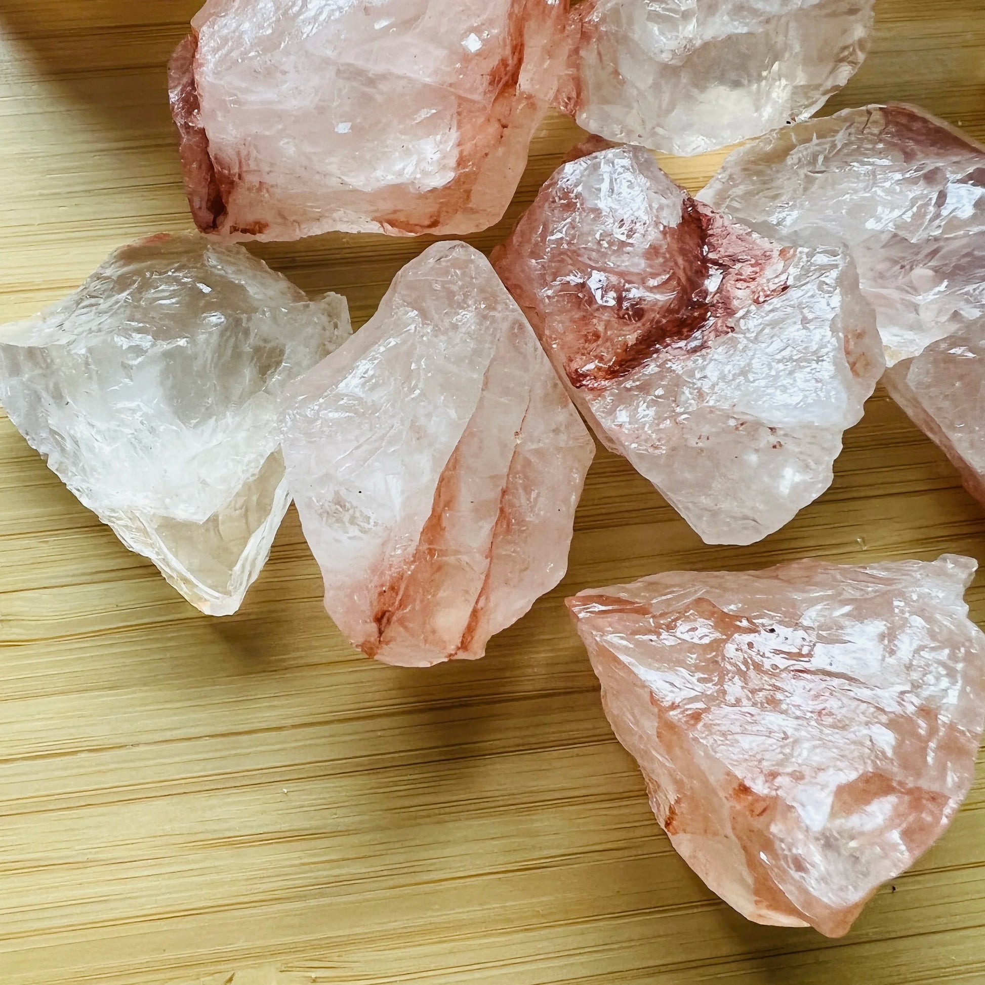 Side perspective of Grade AA Fire Quartz raw stone, showing natural variation, worked with for Grounding and Confidence.