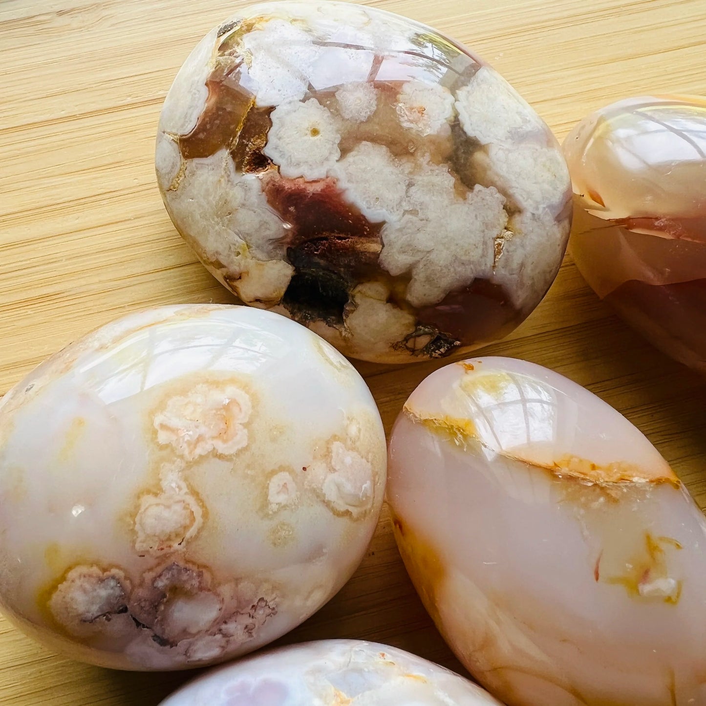 Overhead view of Flower Agate palm stone, drawn on for Love, showing natural inclusions.